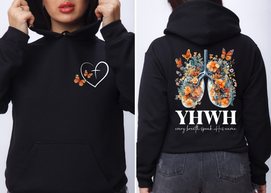 On the front of this custom women's Christian hoodie is a large heart that has a Jesus cross in the center of it, there are two butterflies around the heart. On the back of the sweater is an image of a pair of human lungs made from flowers and butterflies, under the image it says YHWH every breath speaks His name.