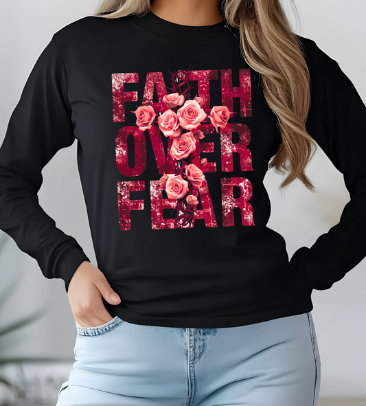 On the front of this Christian vintage long sleeve shirt are the words Faith Over Fear in large block letters with a cross made of thorns in the middle that is covered in roses.