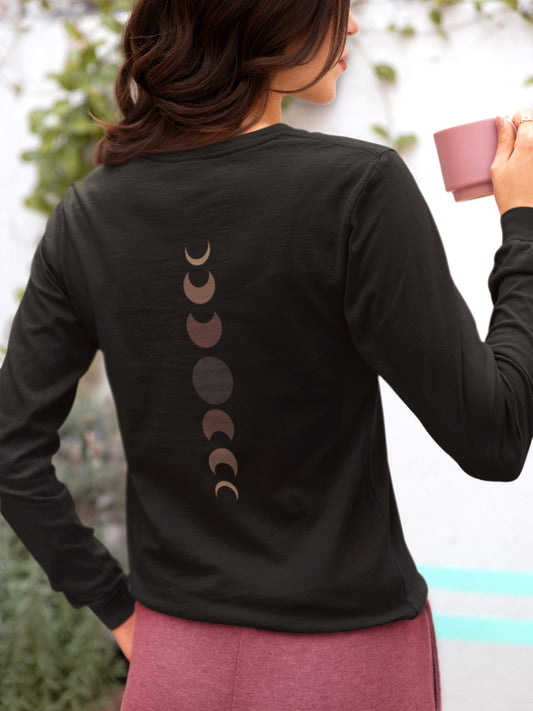 On the back of this custom unisex long sleeve t-shirt from the top of the shirt to the bottom are 7 images of the moon showing the moons cycle, every moon is a different shade of brown.