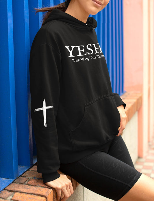 A oversized hoodie, on the front of the hoodie in white are the words Yeshua the same today tomorrow and forever in a old style font, there is also a white Jesus cross on both sleeves of the hooded sweater