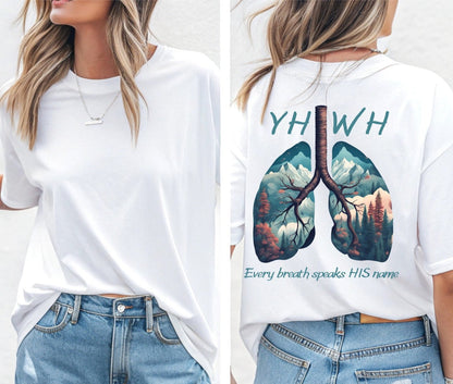 On the back of this handmade custom Christian short sleeve shirt is the word "YHWH" in large blue lettering with an image of a set of lungs with images of mountain scenery in each lung. The words "Every breath speaks His name" are underneath the image of the lungs.