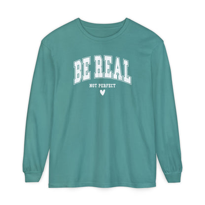 On the front of this custom unisex long sleeve shirt are the words Be Real in large bubble font with the words not perfect underneath the bubble letters, on the bottom there is a heart.