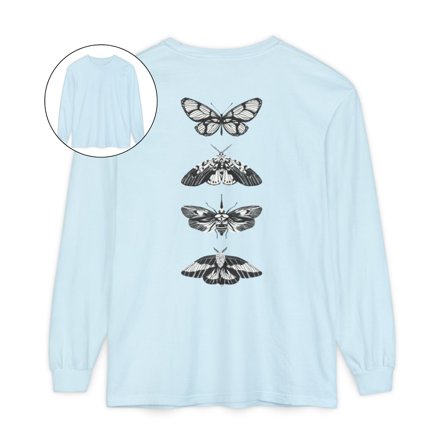 On the back of this long sleeve women's shirt right in between the shoulder blades is a row of black and white butterflies, starting at the top of the back and headed to the bottom of the shirt.