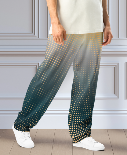 A pair of super soft unisex style wide leg jogger with a ombre pattern that starts as a light orange on the top the fades to a deep teal in the middle of the sweats, there is a polka dot pattern that is light orange throughout the top as well.