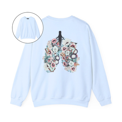 On the back of this women's pullover sweatshirt is an image of a set of lungs, but the lungs are made out of vines with pink and white flowers all over them, there are butterflies sitting in top of the flowers that are light blue in color.