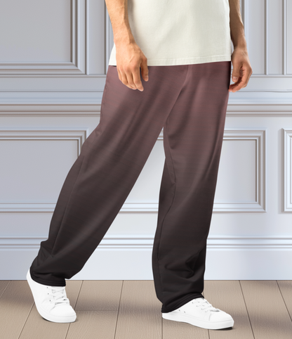 The super soft pair of wide leg unisex joggers that have a ombre pattern starting as a light mauve color on the top of the sweats and fading to a black color at the bottom of the sweats.