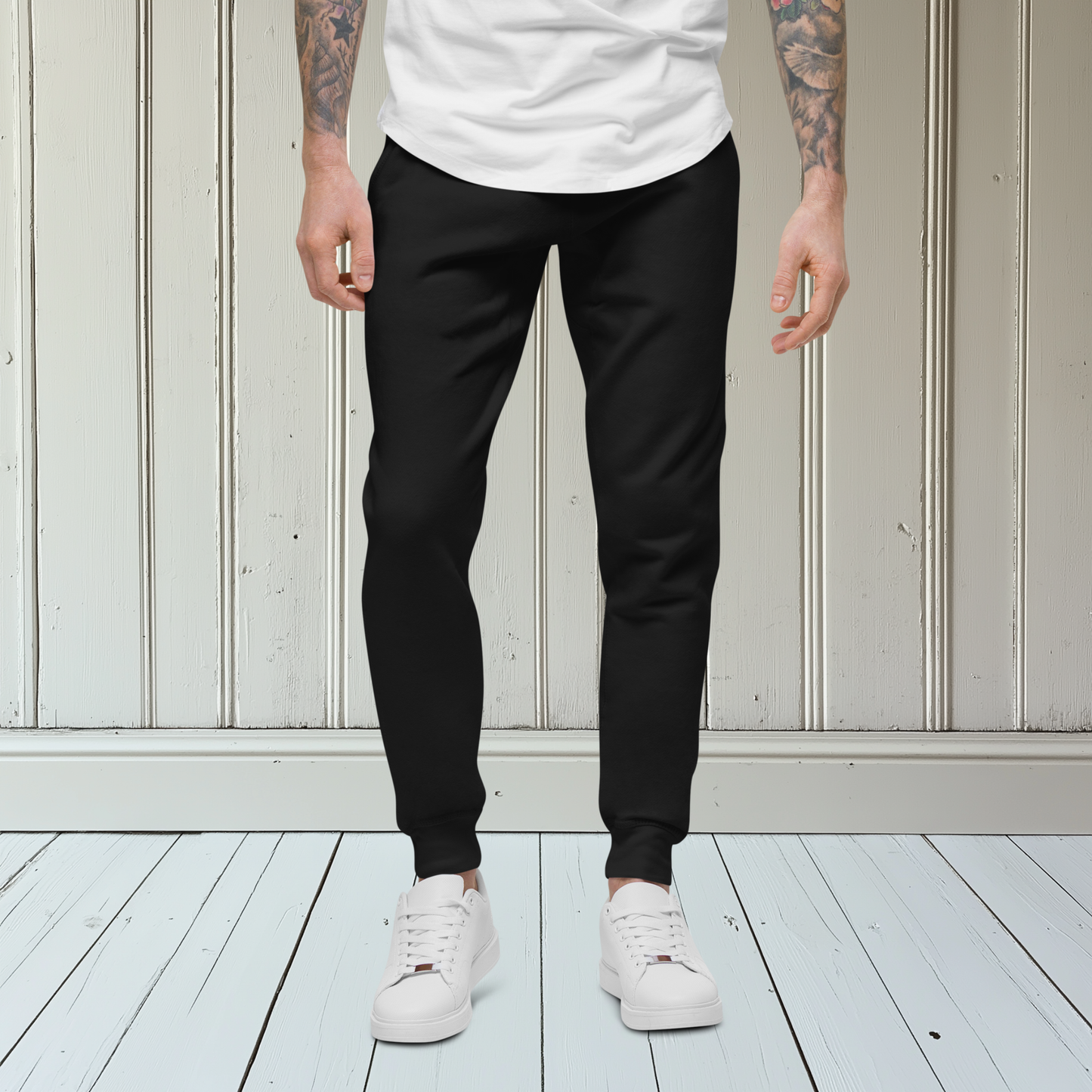 A pair of super soft custom unisex fleece sweatpants with a male lion head on the back calf of the right leg embroidered in silver.