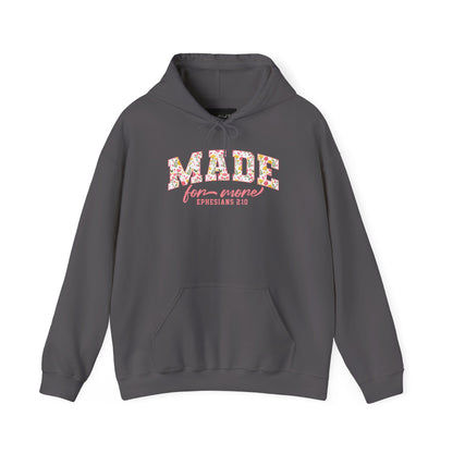 On the front of this custom Christian hoodie is the bible verse the says Made for more Ephesians 2:10, with the word "Made" being large block letters with a pink floral pattern inside the letters, all the other words are in a light pink color.