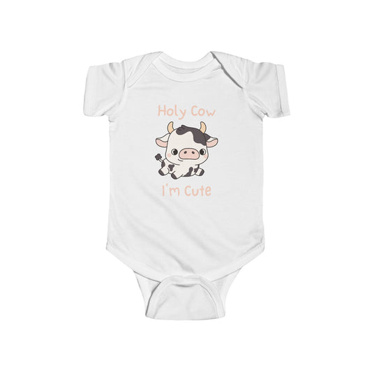 This adorable pink colored super soft bodysuit features an image of a baby cow in the middle with the words 'holy cow I'm cute' in light beige lettering around the image.