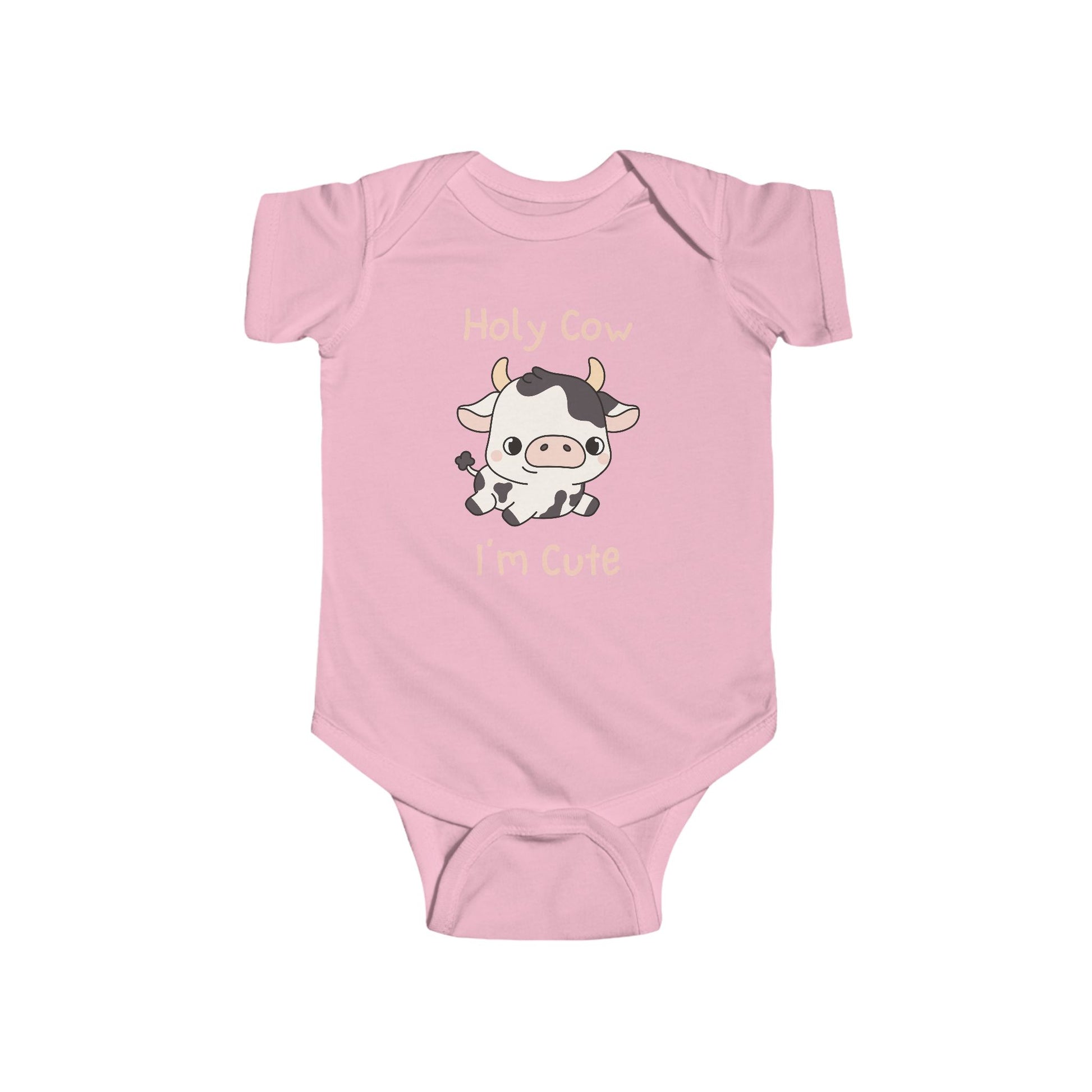 This adorable pink colored super soft bodysuit features an image of a baby cow in the middle with the words 'holy cow I'm cute' in light beige lettering around the image.