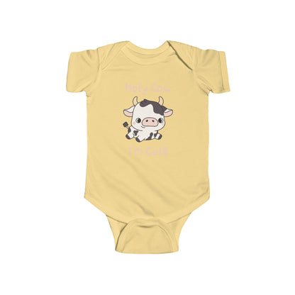 This adorable pink colored super soft bodysuit features an image of a baby cow in the middle with the words 'holy cow I'm cute' in light beige lettering around the image.
