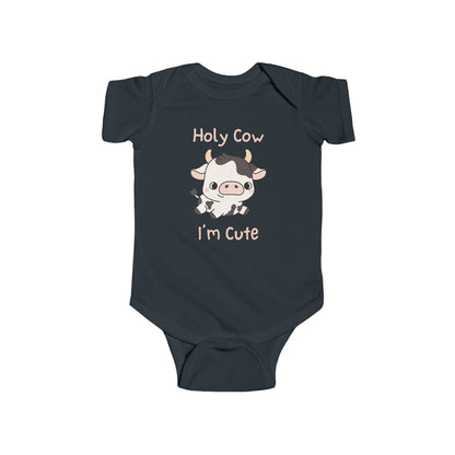 This adorable pink colored super soft bodysuit features an image of a baby cow in the middle with the words 'holy cow I'm cute' in light beige lettering around the image.