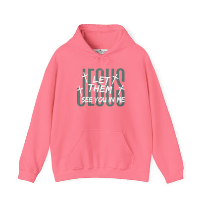 On the front of this custom Christian hoodie it says Jesus in large letters with the words Let them see you in me overlayed overtop of Jesus, there are crosses around the wording.