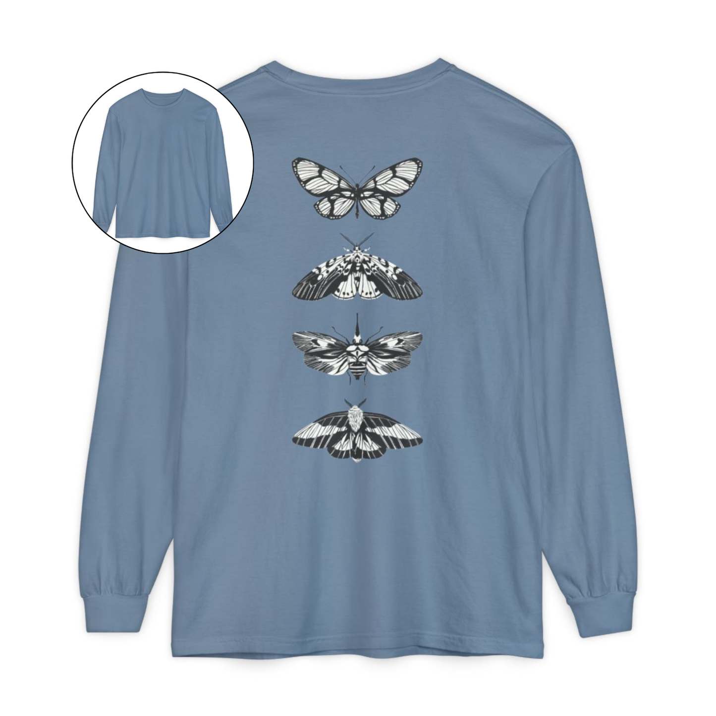 On the back of this long sleeve women's shirt right in between the shoulder blades is a row of black and white butterflies, starting at the top of the back and headed to the bottom of the shirt.