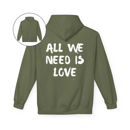 On the back of this custom unisex hoodie are the words all we need is love, the words look like they have been spray painted onto the sweater.