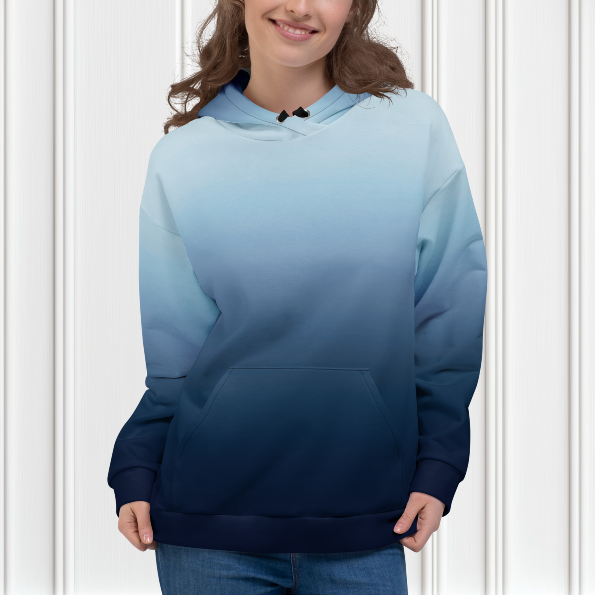 A custom handmade unisex pullover hooded sweatshirt with an ombre design with the top of the hoodie being a very light blue color then it slowly shifting to a navy blue at the bottom of the hoodie.