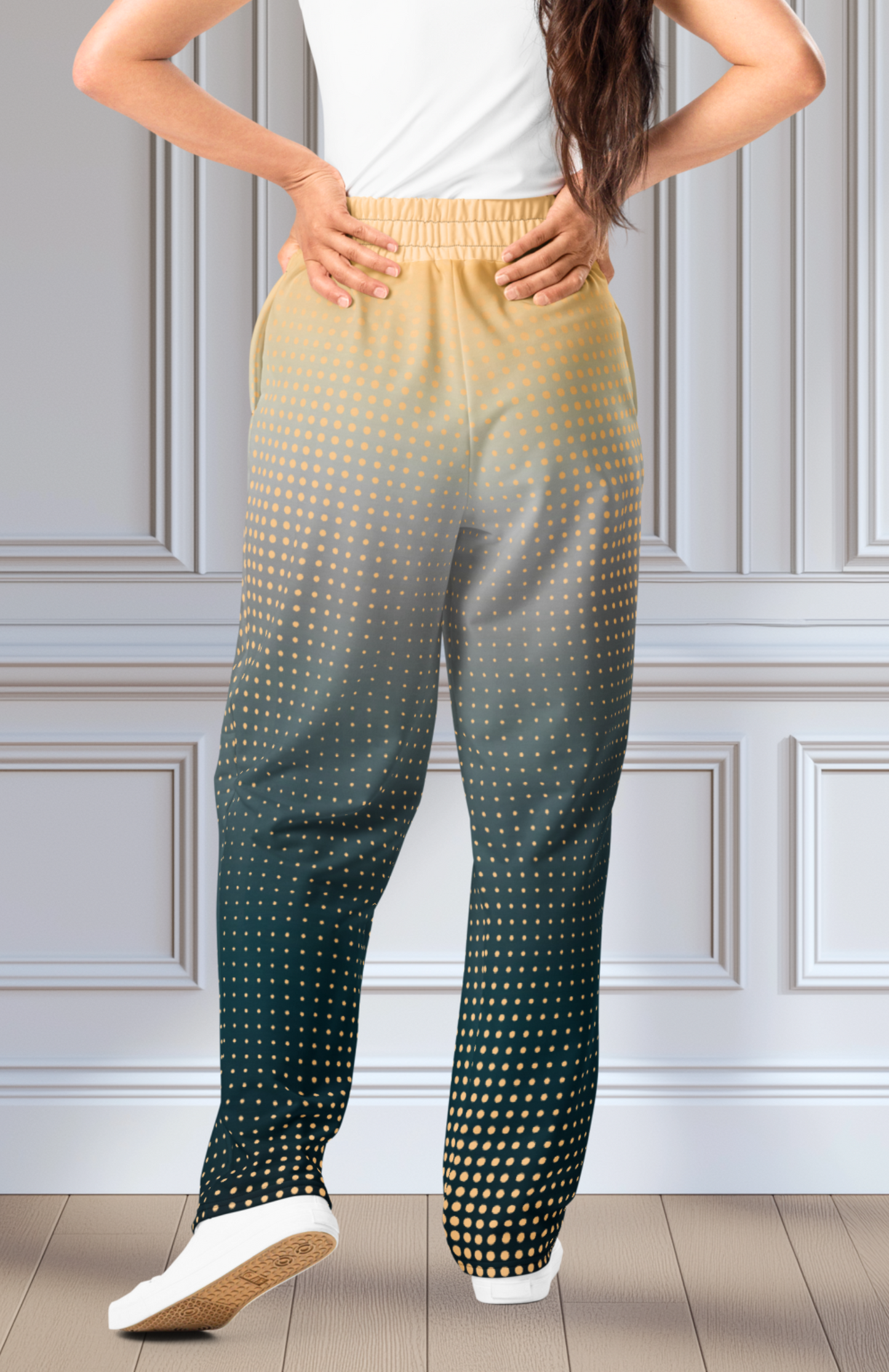 A pair of super soft unisex style wide leg jogger with a ombre pattern that starts as a light orange on the top the fades to a deep teal in the middle of the sweats, there is a polka dot pattern that is light orange throughout the top as well.