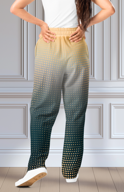 A pair of super soft unisex style wide leg jogger with a ombre pattern that starts as a light orange on the top the fades to a deep teal in the middle of the sweats, there is a polka dot pattern that is light orange throughout the top as well.