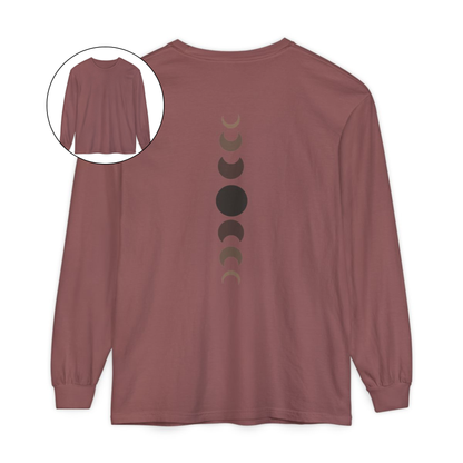 On the back of this custom unisex long sleeve t-shirt from the top of the shirt to the bottom are 7 images of the moon showing the moons cycle, every moon is a different shade of brown.