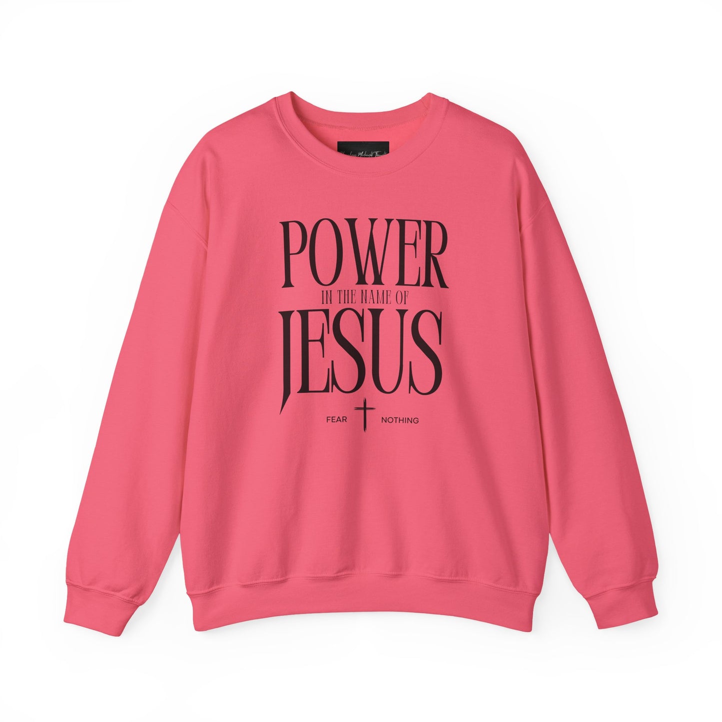On the front of this Christian pullover sweatshirt it says Power In The Name Of Jesus with a Jesus cross underneath it, on either side of the cross are the words Fear and Nothing.