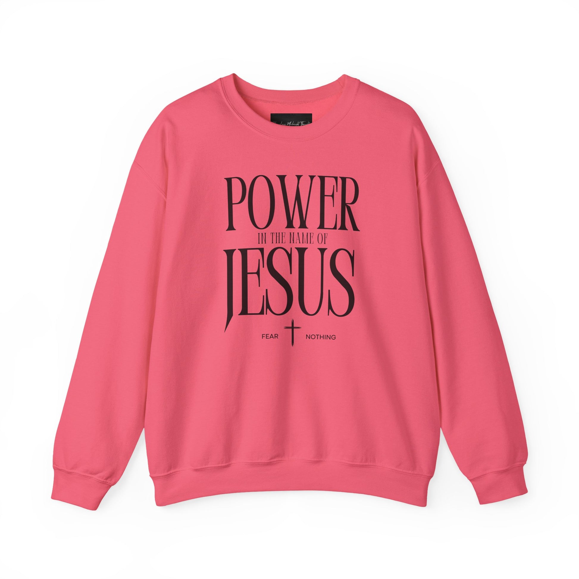 On the front of this Christian pullover sweatshirt it says Power In The Name Of Jesus with a Jesus cross underneath it, on either side of the cross are the words Fear and Nothing.