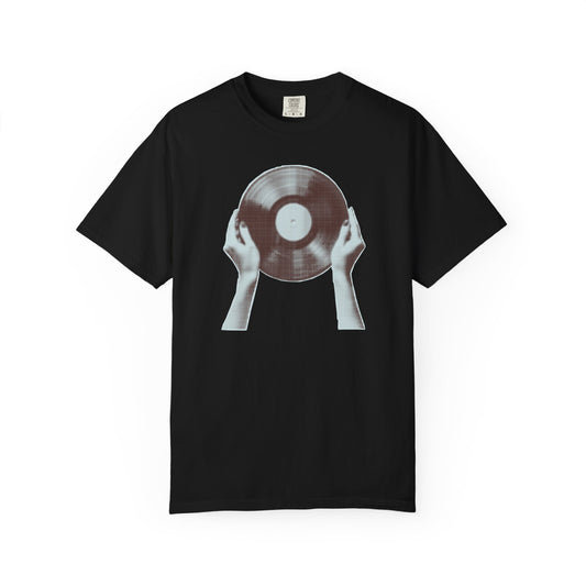 On the front of this custom vintage short sleeve shirt is a large vinyl record being held by two hands on either side, the image is in black and white giving it a more vintage look.