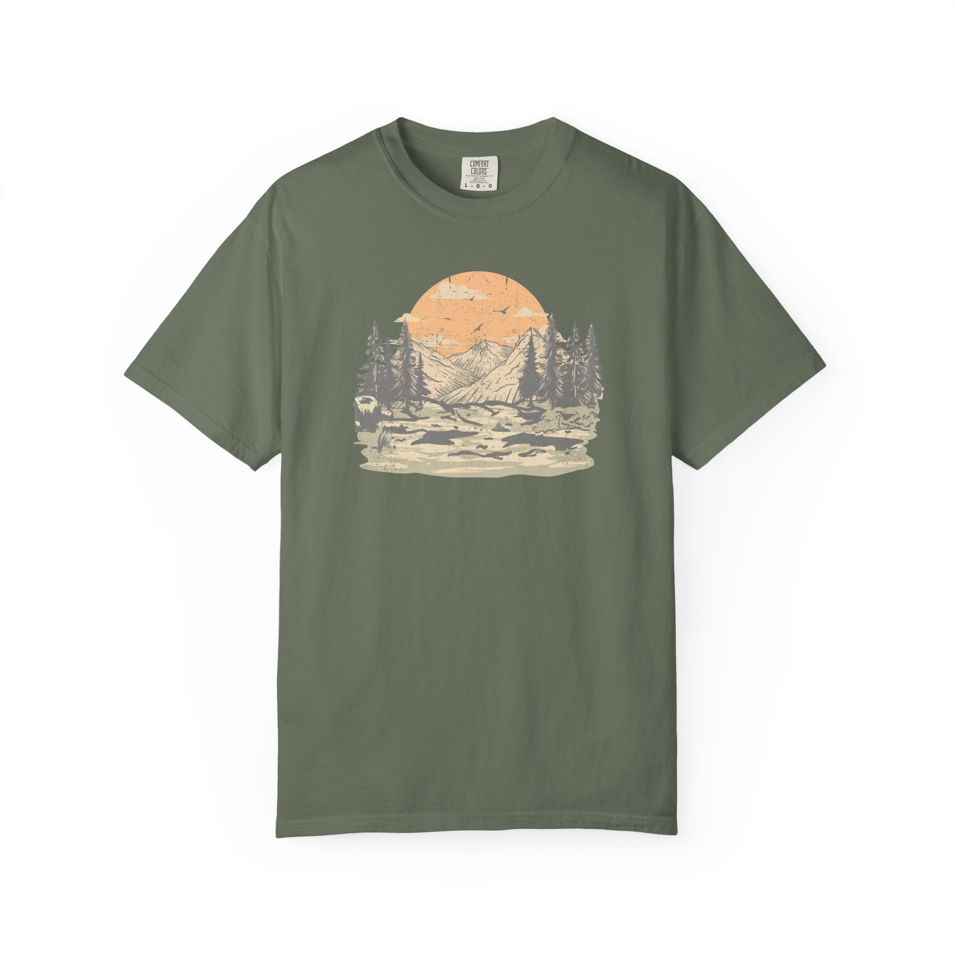 On the front of this custom comfort colors short sleeve t-shirt is a large vintage image of a large valley that opens up to a mountain range with pine trees , there is a large sun in the background with birds flying all around, this t-shirt is completely vintage.