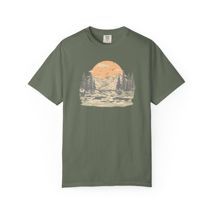 On the front of this custom comfort colors short sleeve t-shirt is a large vintage image of a large valley that opens up to a mountain range with pine trees , there is a large sun in the background with birds flying all around, this t-shirt is completely vintage.