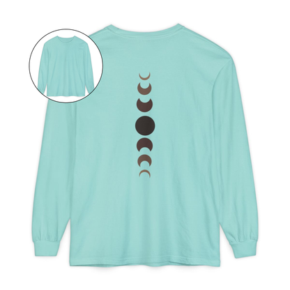 On the back of this custom unisex long sleeve t-shirt from the top of the shirt to the bottom are 7 images of the moon showing the moons cycle, every moon is a different shade of brown.