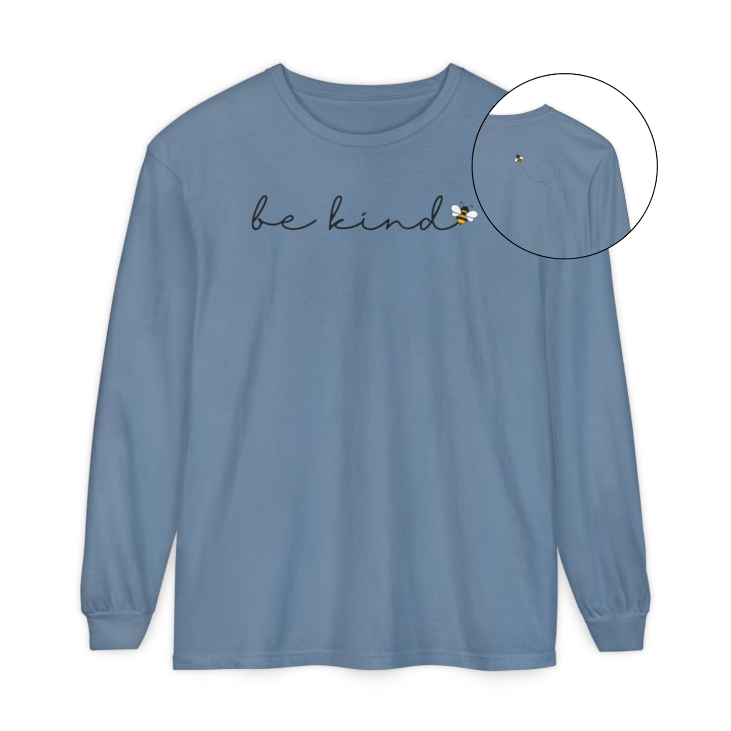 On the front of this custom unisex long sleeve shirt are the words be kind in a simple cursive font, with a bumble bee on the right side of the letter kind, on the back right shoulder there is an image of a bumble bee flying and leaving a trail behind it in the shape of a heart.