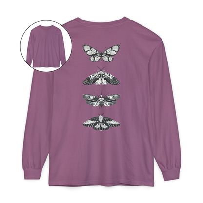 On the back of this long sleeve women's shirt right in between the shoulder blades is a row of black and white butterflies, starting at the top of the back and headed to the bottom of the shirt.