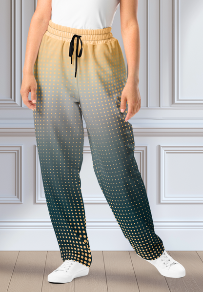 A pair of super soft unisex style wide leg jogger with a ombre pattern that starts as a light orange on the top the fades to a deep teal in the middle of the sweats, there is a polka dot pattern that is light orange throughout the top as well.