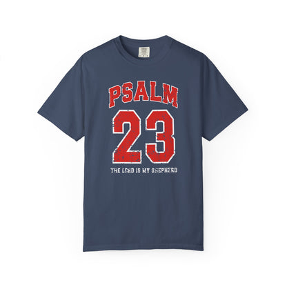 On the front side of this custom vintage t-shirt are the words Psalm 23 The Lord Is My Shepherd, it is with red and white block lettering.