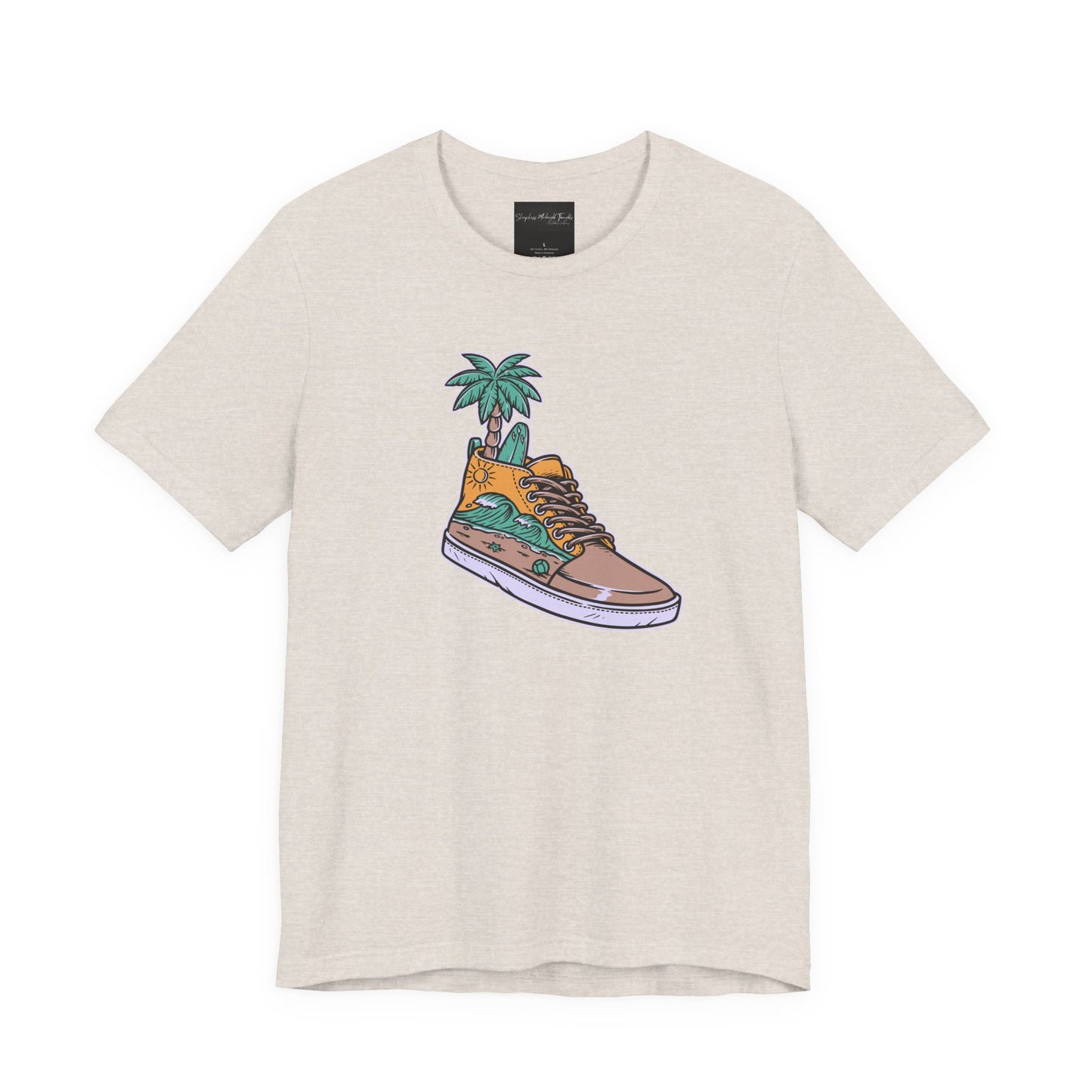 On the front of this custom handmade short sleeve shirt is an image of a high top running shoe with ocean waves running along the side of the shoe, coming out of the top of the shoe where your foot goes is a palm tree and a surf board.
