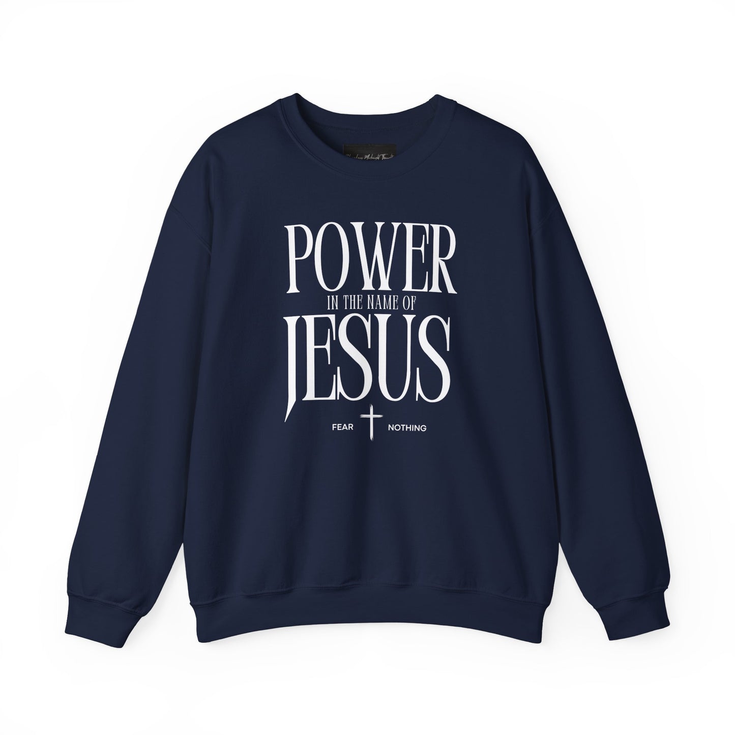 On the front of this Christian pullover sweatshirt it says Power In The Name Of Jesus with a Jesus cross underneath it, on either side of the cross are the words Fear and Nothing.