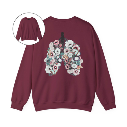 On the back of this women's pullover sweatshirt is an image of a set of lungs, but the lungs are made out of vines with pink and white flowers all over them, there are butterflies sitting in top of the flowers that are light blue in color.