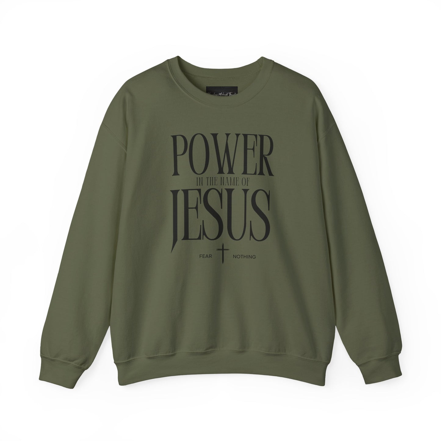 On the front of this Christian pullover sweatshirt it says Power In The Name Of Jesus with a Jesus cross underneath it, on either side of the cross are the words Fear and Nothing.