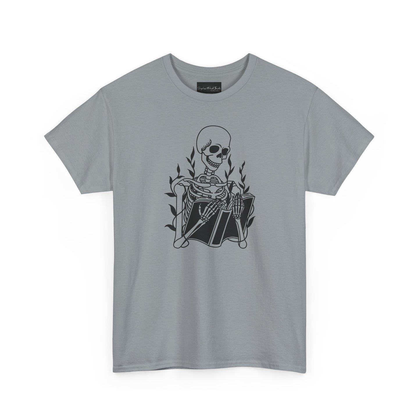 On the front of this custom unisex short sleeve shirt is a large image of a skeleton reading a book, there are vines with leaves on them behind the skeleton.