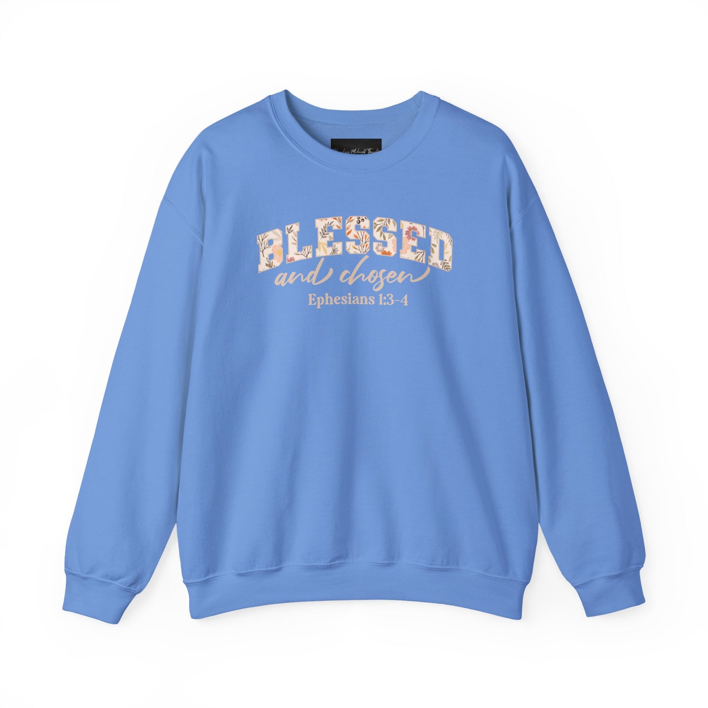 On the front of this custom Christian sweatshirt is the bible verse Blessed and Chosen Ephesians 1:3-4 with the word Blessed being in large bubble letters with a floral pattern on the inside of the letters.