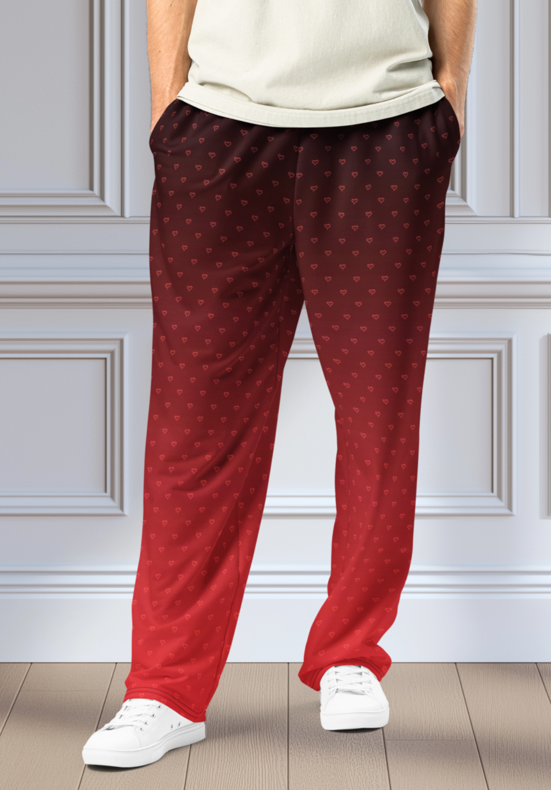 A pair of wide leg ombre sweatpants with the top of the sweats being black and then it fading to a bright red at the bottom of the pants, there are a bunch of red hearts overlayed on the top that then blend into the same shade of red at the bottom of the sweats.