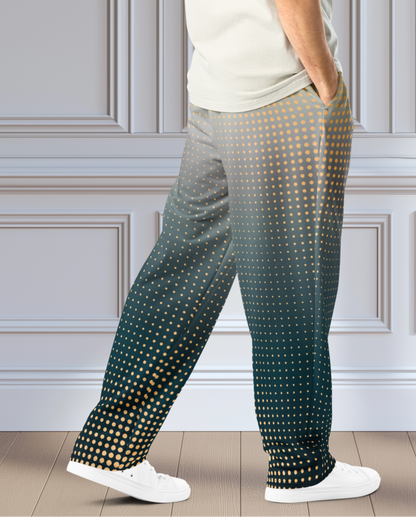 A pair of super soft unisex style wide leg jogger with a ombre pattern that starts as a light orange on the top the fades to a deep teal in the middle of the sweats, there is a polka dot pattern that is light orange throughout the top as well.
