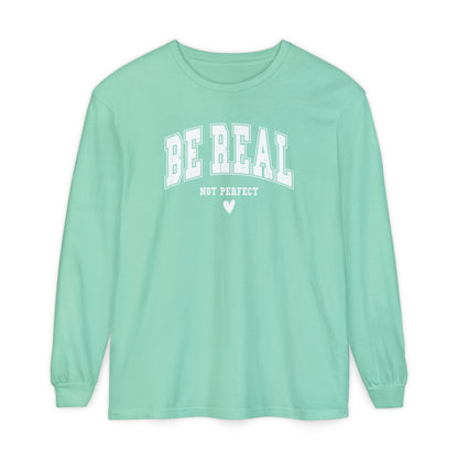 On the front of this custom unisex long sleeve shirt are the words Be Real in large bubble font with the words not perfect underneath the bubble letters, on the bottom there is a heart.