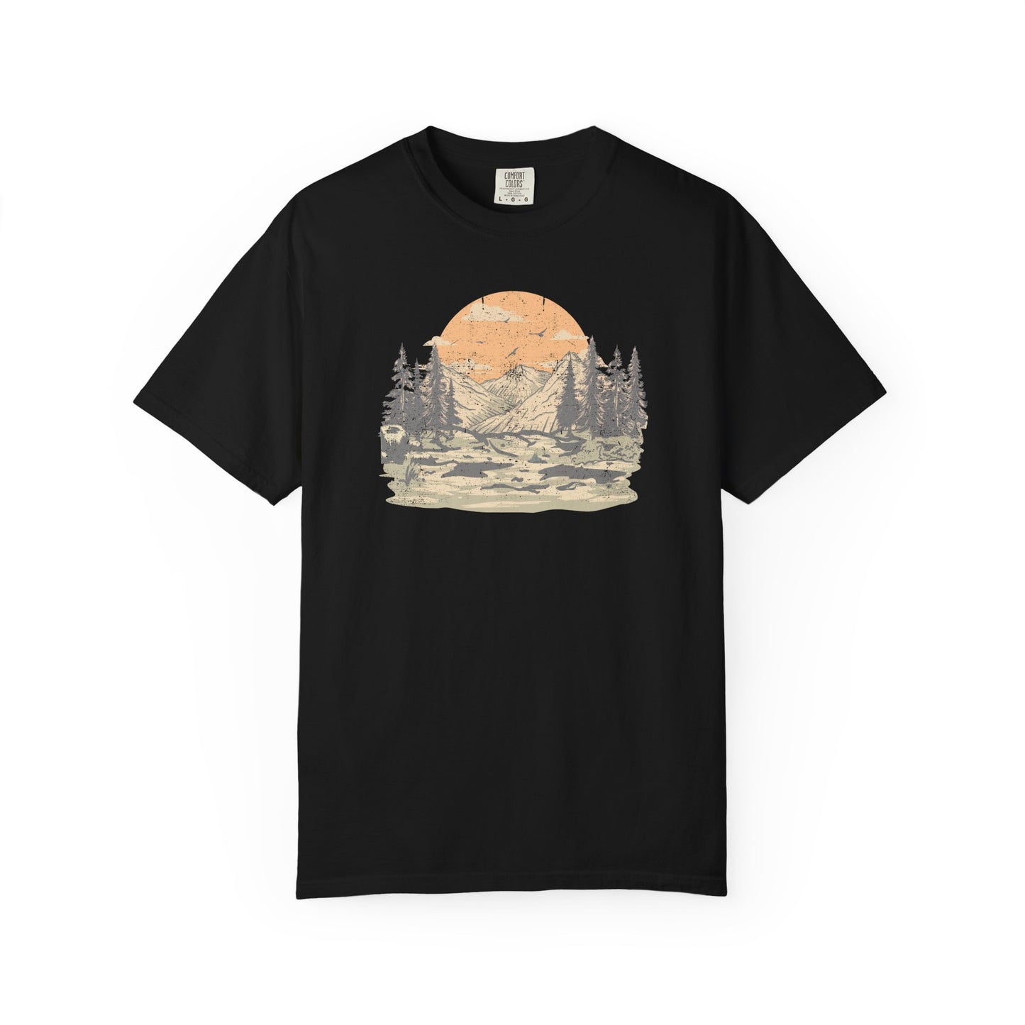 On the front of this custom comfort colors short sleeve t-shirt is a large vintage image of a large valley that opens up to a mountain range with pine trees , there is a large sun in the background with birds flying all around, this t-shirt is completely vintage.