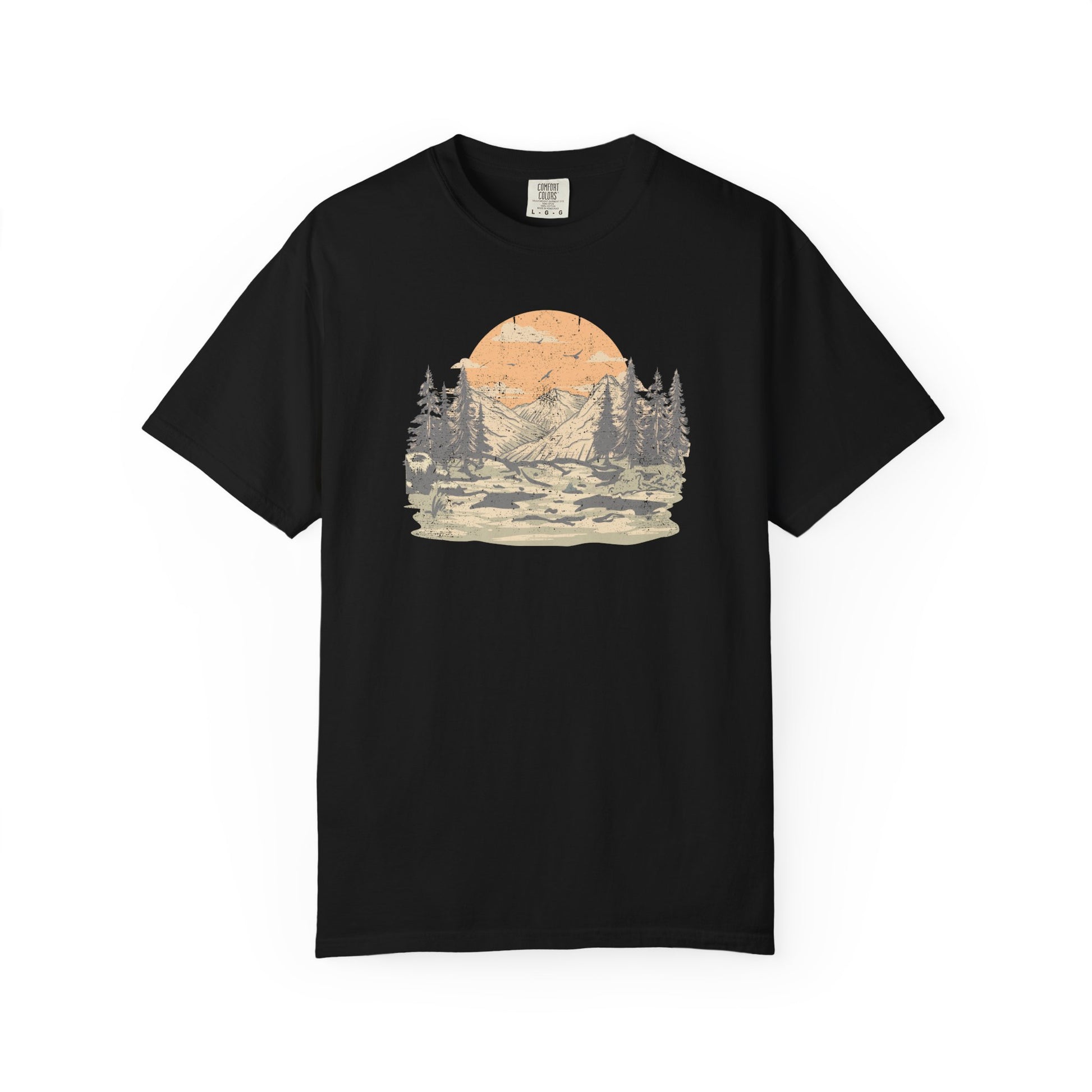 On the front of this custom comfort colors short sleeve t-shirt is a large vintage image of a large valley that opens up to a mountain range with pine trees , there is a large sun in the background with birds flying all around, this t-shirt is completely vintage.