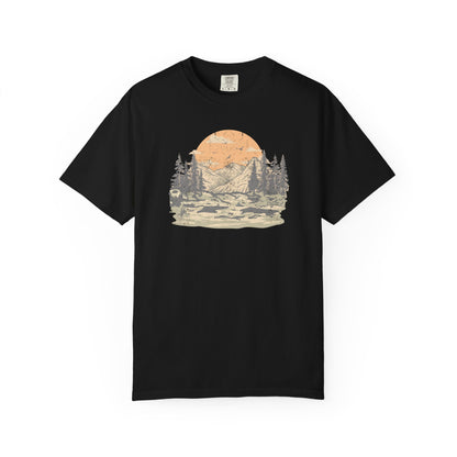 On the front of this custom comfort colors short sleeve t-shirt is a large vintage image of a large valley that opens up to a mountain range with pine trees , there is a large sun in the background with birds flying all around, this t-shirt is completely vintage.