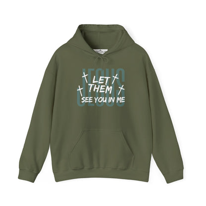 On the front of this custom Christian hoodie it says Jesus in large letters with the words Let them see you in me overlayed overtop of Jesus, there are crosses around the wording.