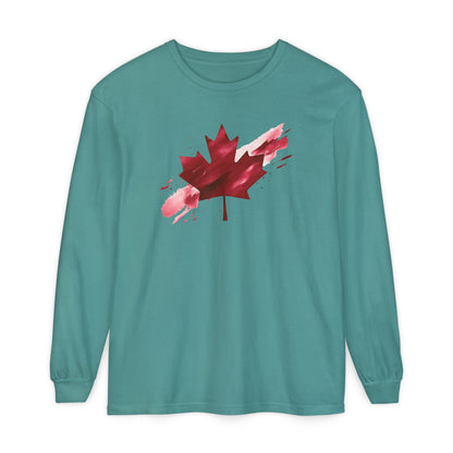 On the front of this unisex long sleeve shirt is an image of a Canadian maple leaf that is bright red, it looks like it has been spray painted onto the front of the shirt.