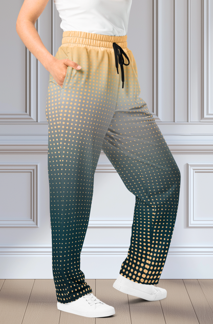 A pair of super soft unisex style wide leg jogger with a ombre pattern that starts as a light orange on the top the fades to a deep teal in the middle of the sweats, there is a polka dot pattern that is light orange throughout the top as well.