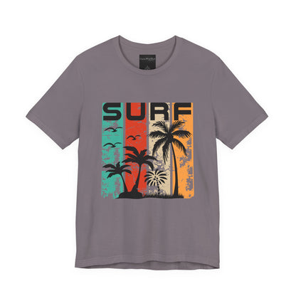 On the front of this custom vacation shirt is the word SURF in large letters at the top of the shirt, each letter has a different colored line through it to the bottom, there are images of palm trees and birds flying underneath the word.