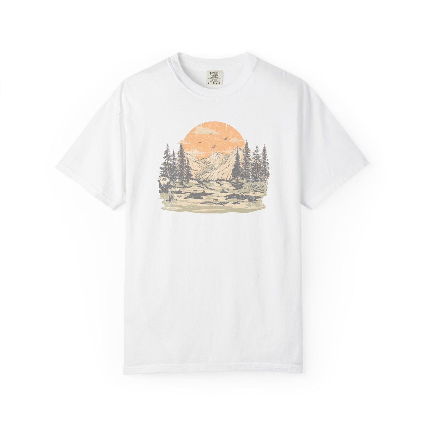 On the front of this custom comfort colors short sleeve t-shirt is a large vintage image of a large valley that opens up to a mountain range with pine trees , there is a large sun in the background with birds flying all around, this t-shirt is completely vintage.